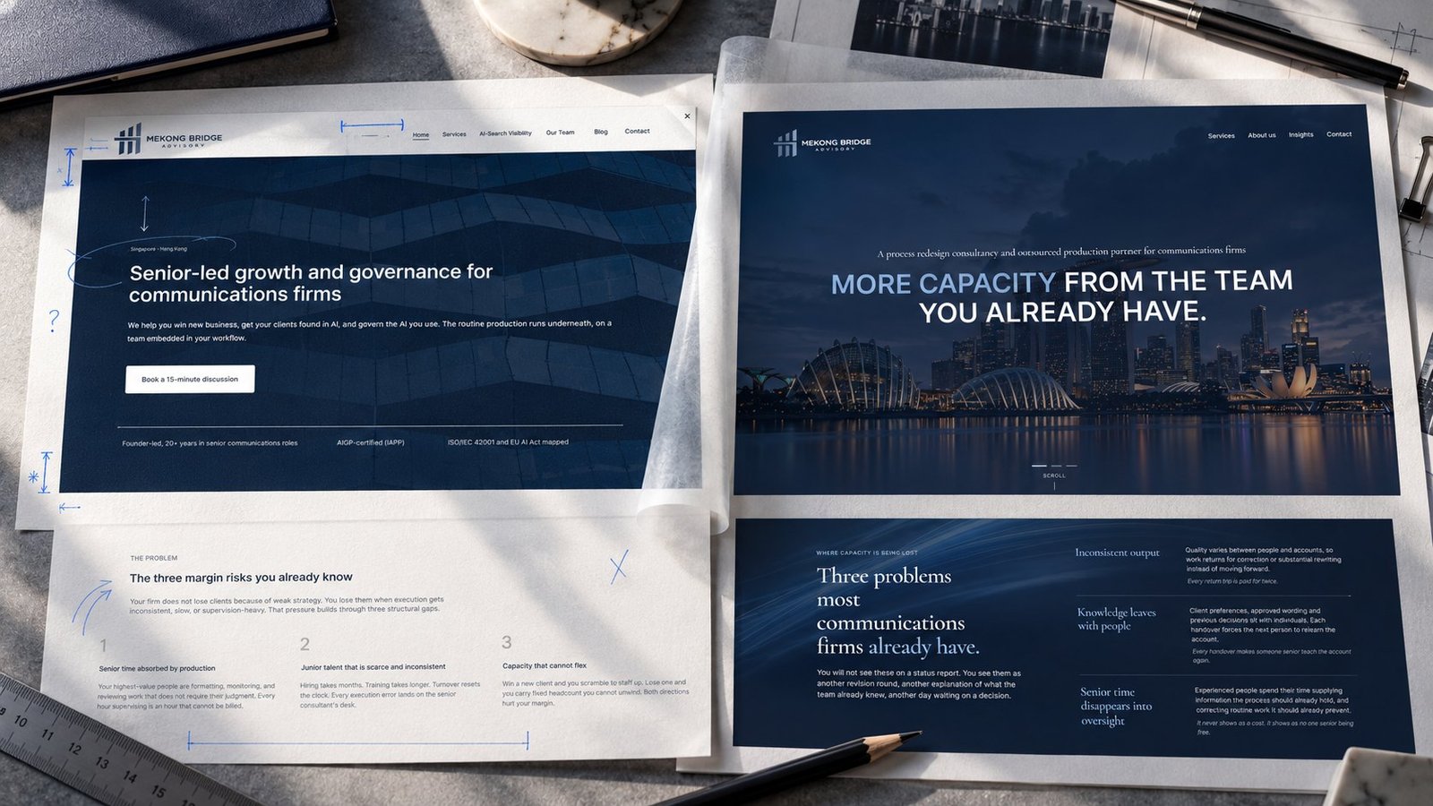 Printed before-and-after Mekong Bridge Advisory website layouts with handwritten design annotations on a desk.