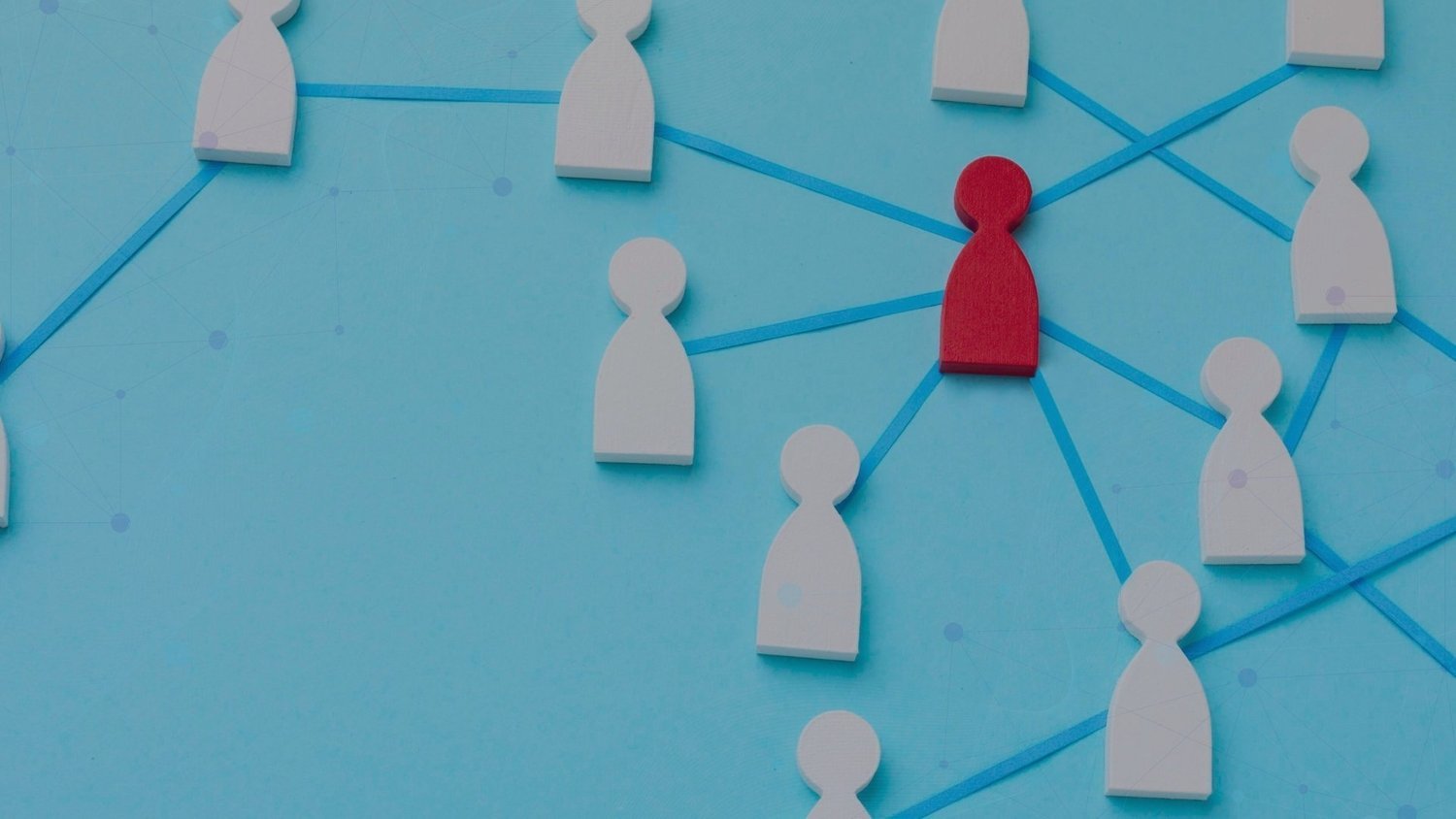 Red wooden figure at the centre of a network of white figures connected by blue lines.